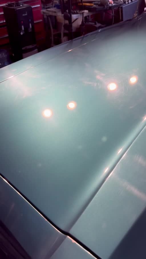Green Pontiac Grand Prix: hood close-up