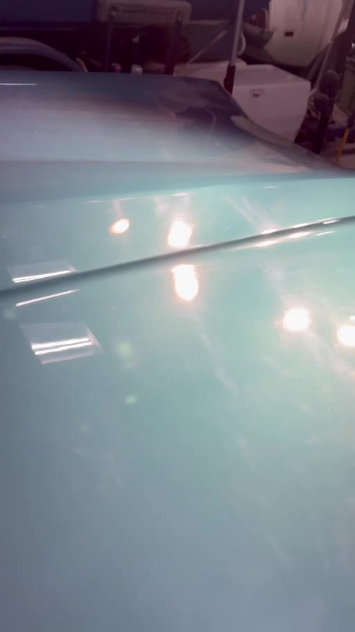 Green Pontiac Grand Prix: surface reflections